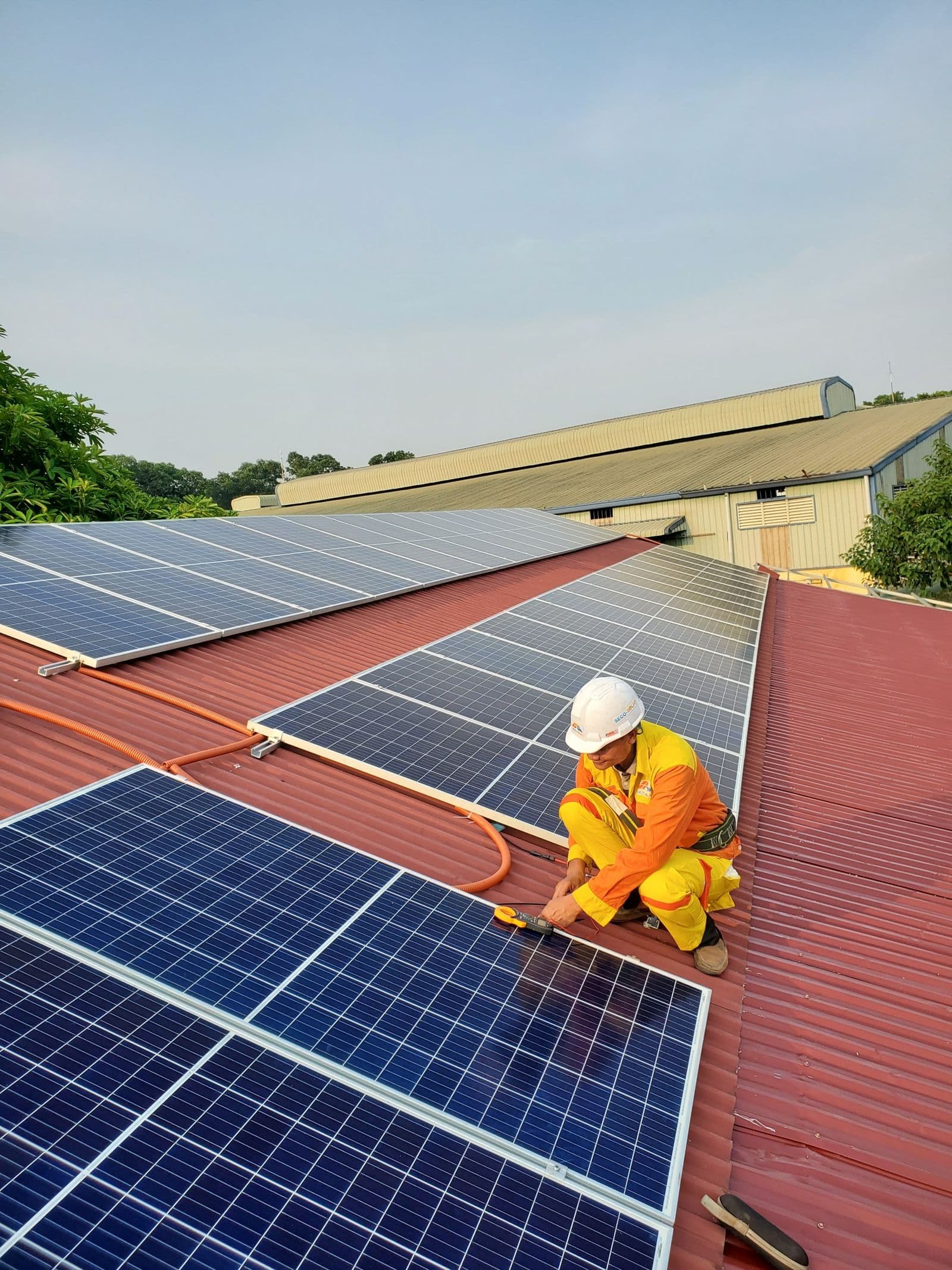 Technician fitting a rooftop solar panel